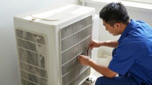 HVAC technician repairing an air conditioner in a home.