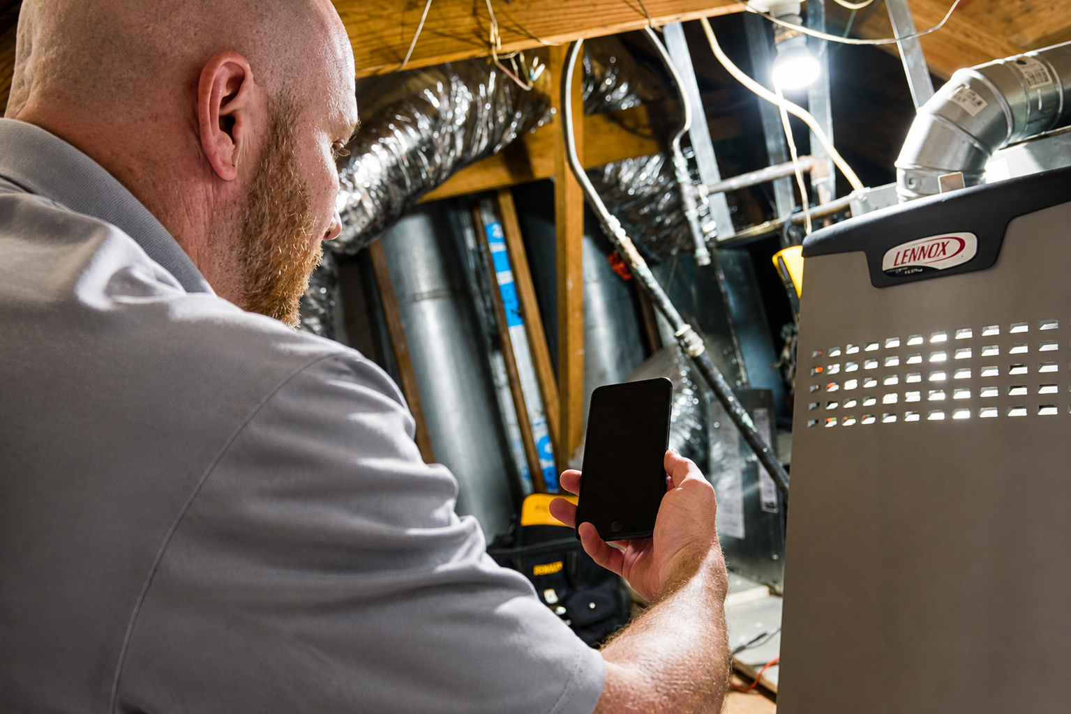 911 Mechanical technician inspecting an older furnace in Michigan