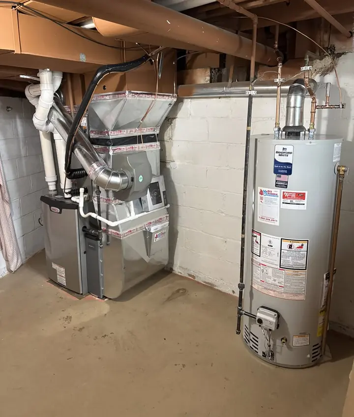 Bradford White tank water heater installed beside a new Lennox furnace in a Metro Detroit basement